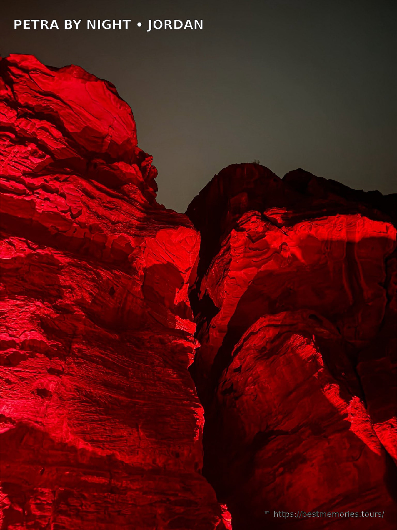 Red-lit Petra sandstone canyon on an evening Petra tourism visit in Jordan