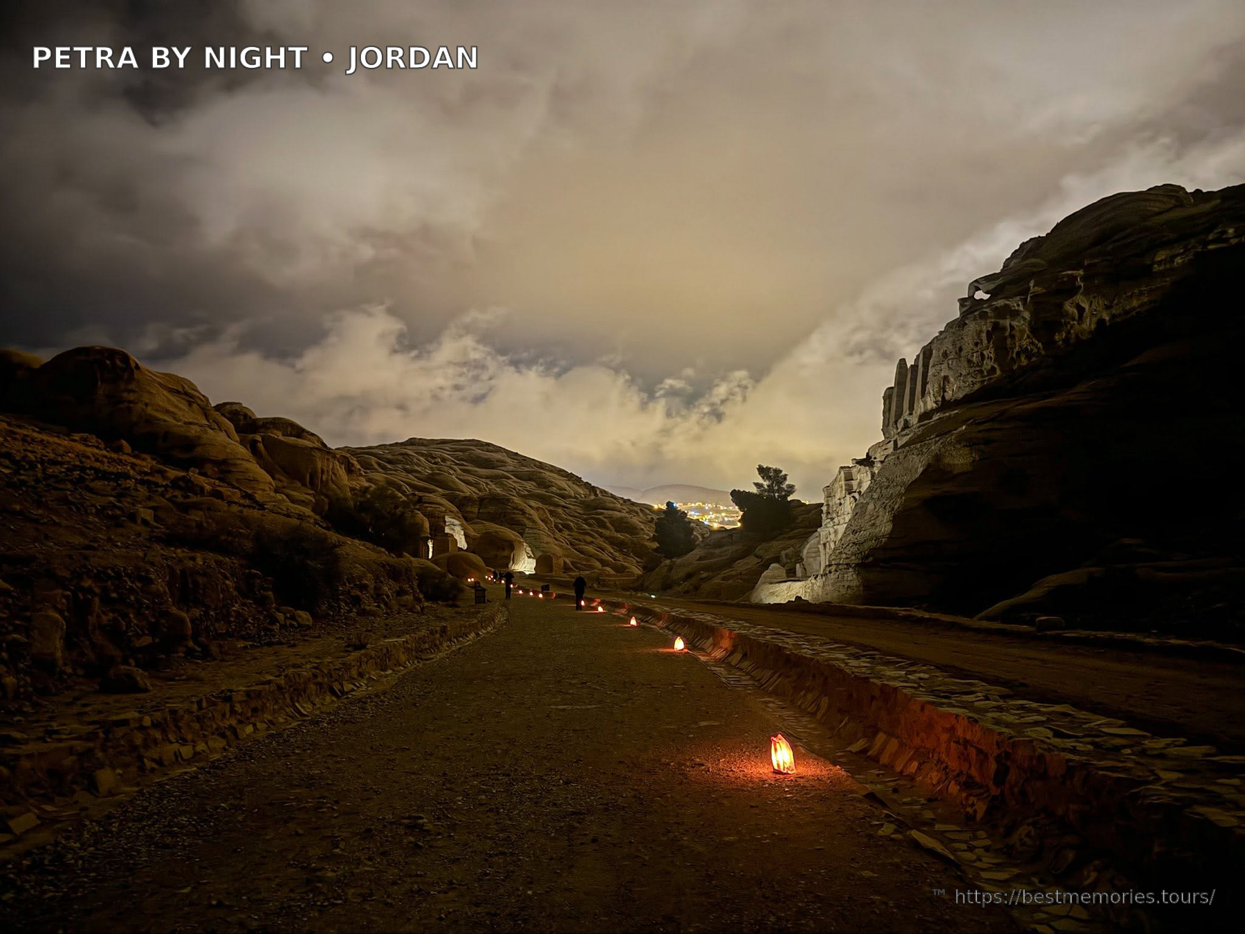 Illuminated rock-cut tombs and mountains at Petra archaeological site, Jordan