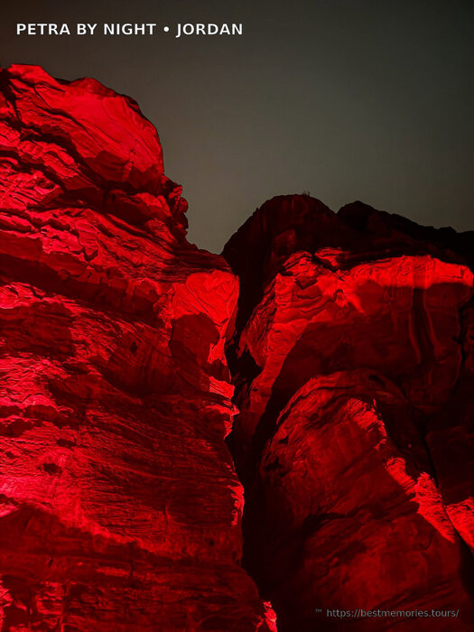 Red-lit Petra sandstone canyon on an evening Petra tourism visit in Jordan