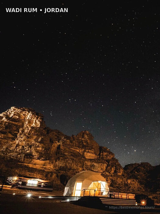 Glamping camp and illuminated mountains at night in Wadi Rum, Jordan