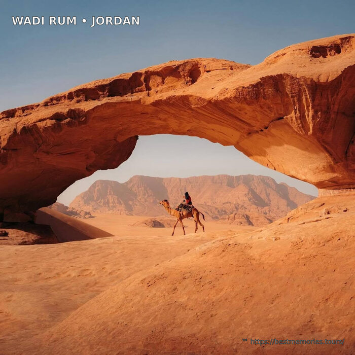 Sunset camel ride beneath a Wadi Rum rock arch, Jordan